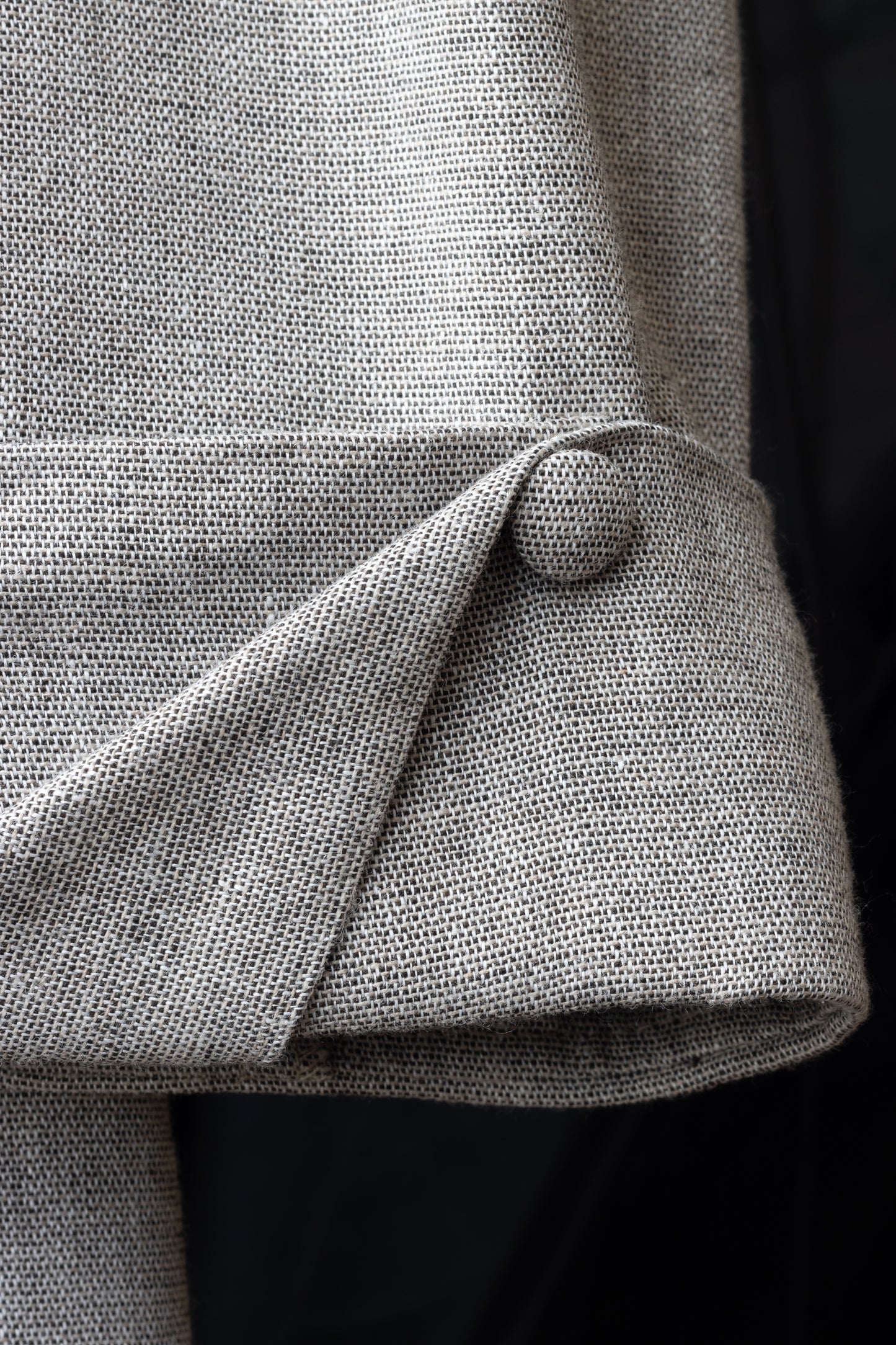 Close-up of cuff with linen button – detail shot of folded sleeve