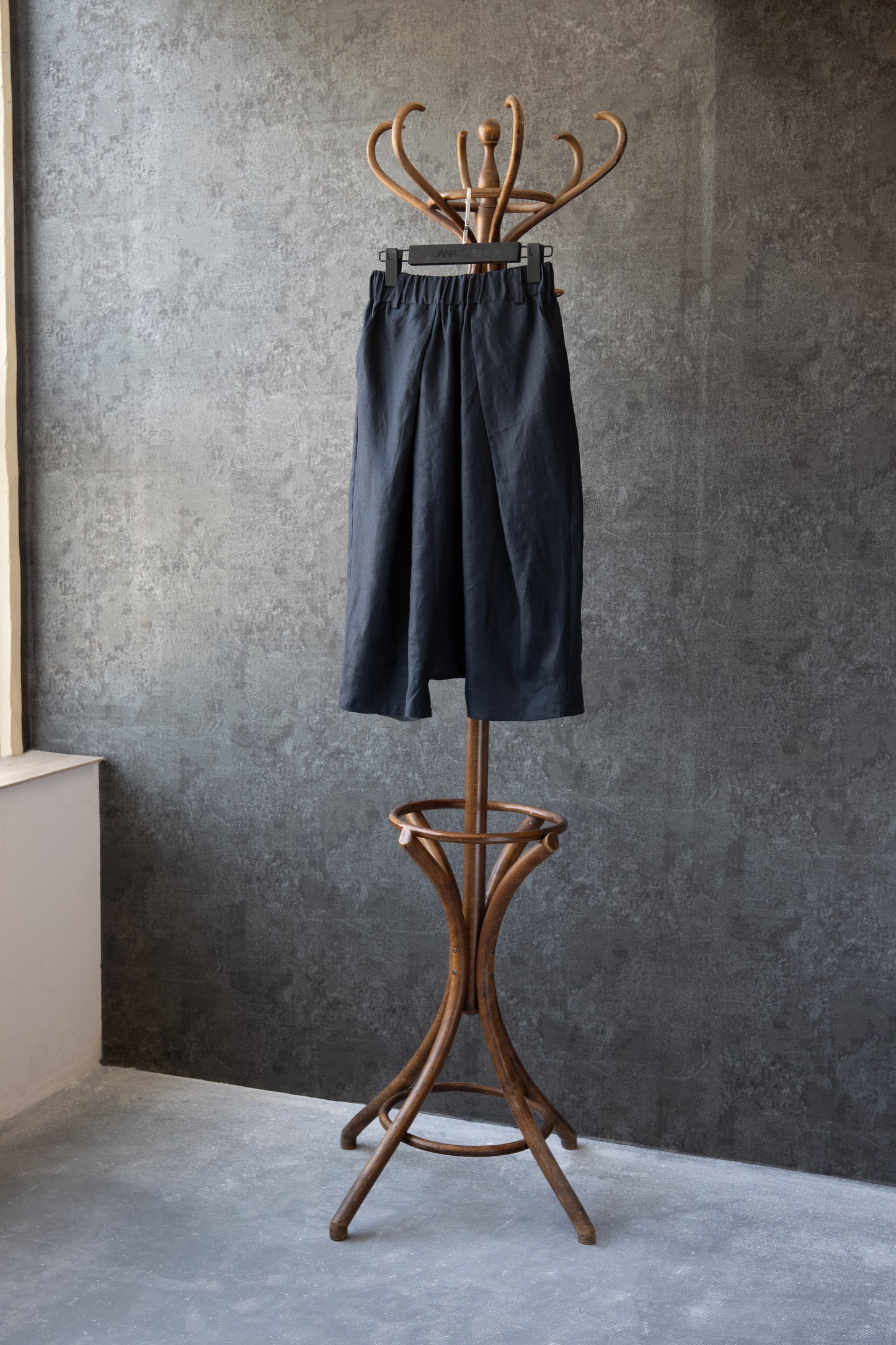 Pants displayed on hanger in artistic studio setting