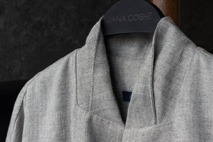 Minimalist collar close-up with hanger branding "JANA COSHÉ"