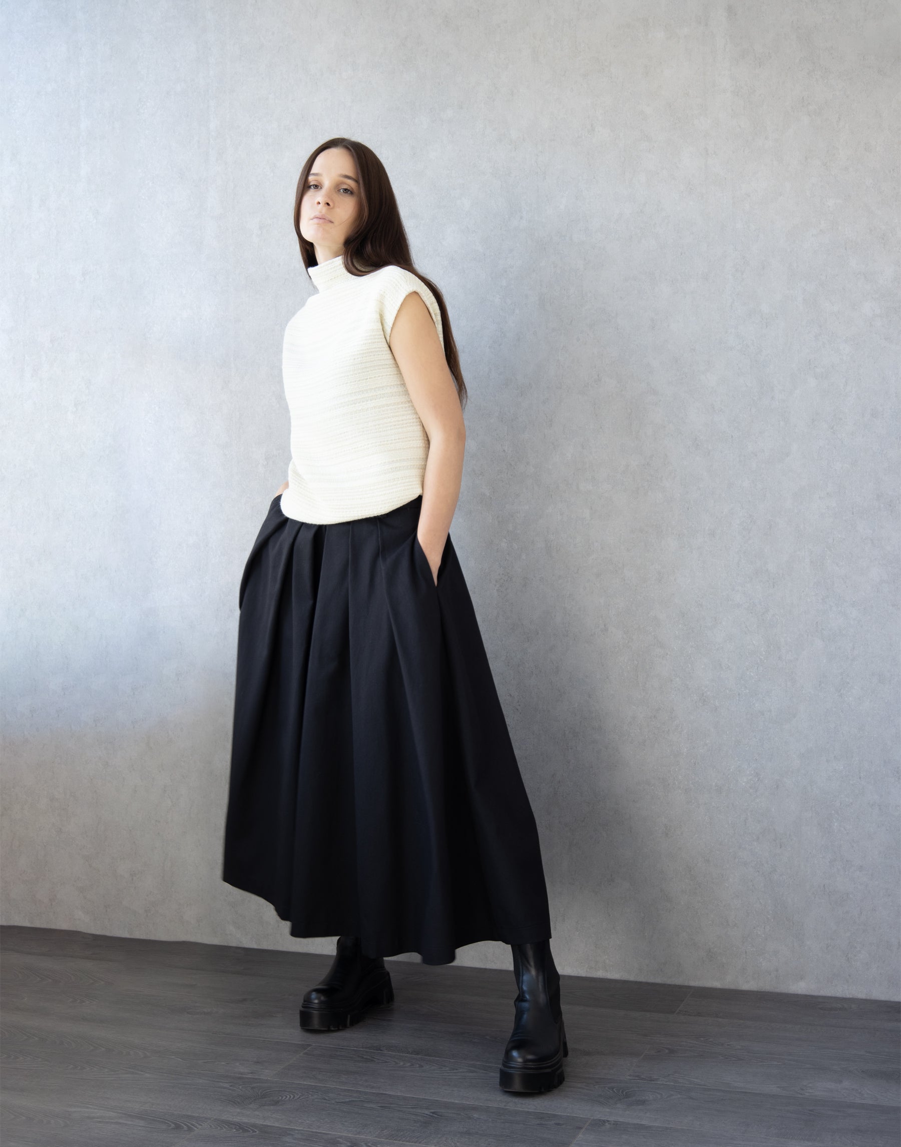 Side view of avant-garde Black skirt pants revealing flowing wide-leg structure