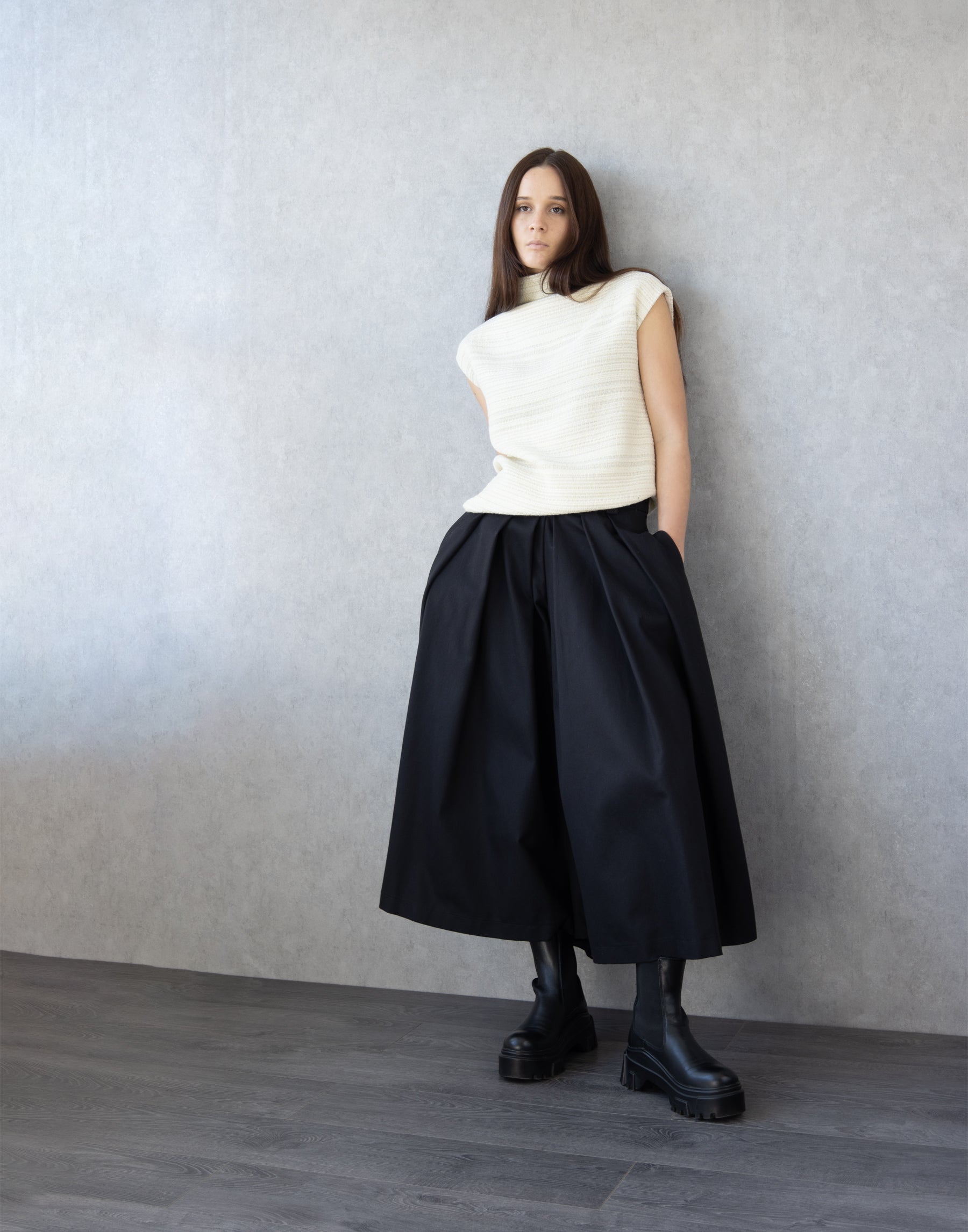 Black cotton skirt pants showing pleated volume and high waist silhouette Black Cotton Trousers
