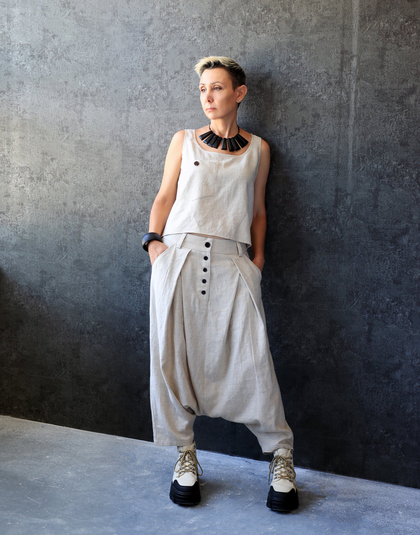 Woman in Drop Crotch Pleated Trousers