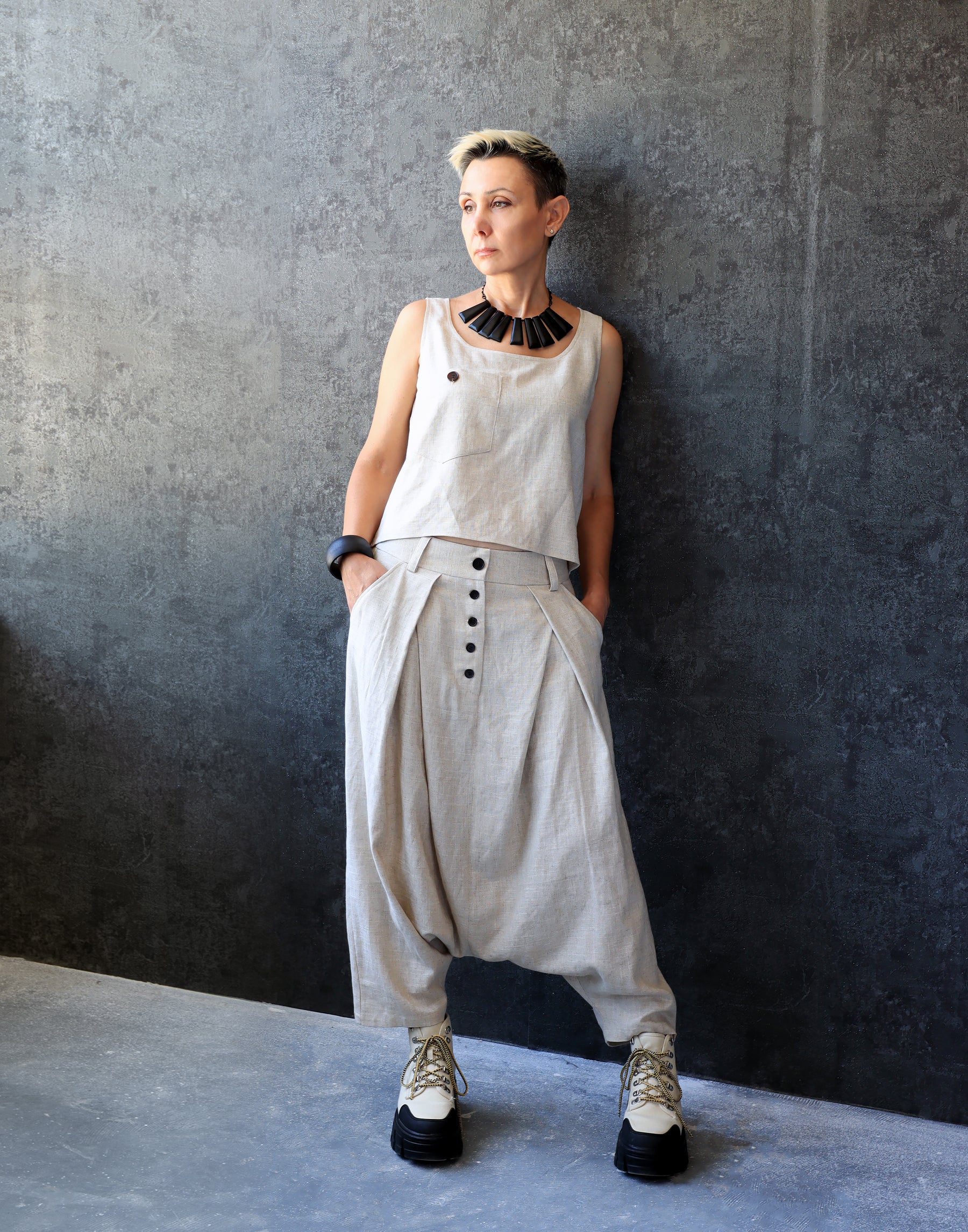 Woman in Drop Crotch Pleated Trousers