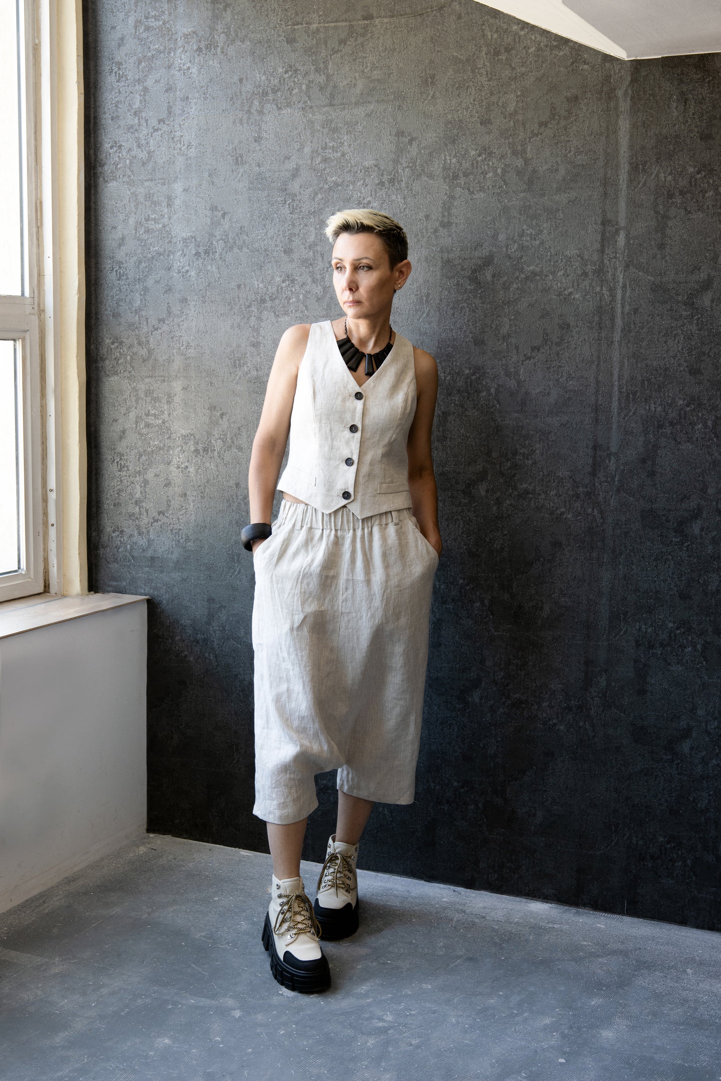 Woman wearing off-white linen drop-crotch pants with matching vest – full outfit – Jana Coshe