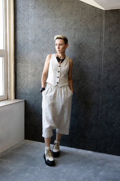 Woman wearing off-white linen drop-crotch pants with matching vest – full outfit – Jana Coshe