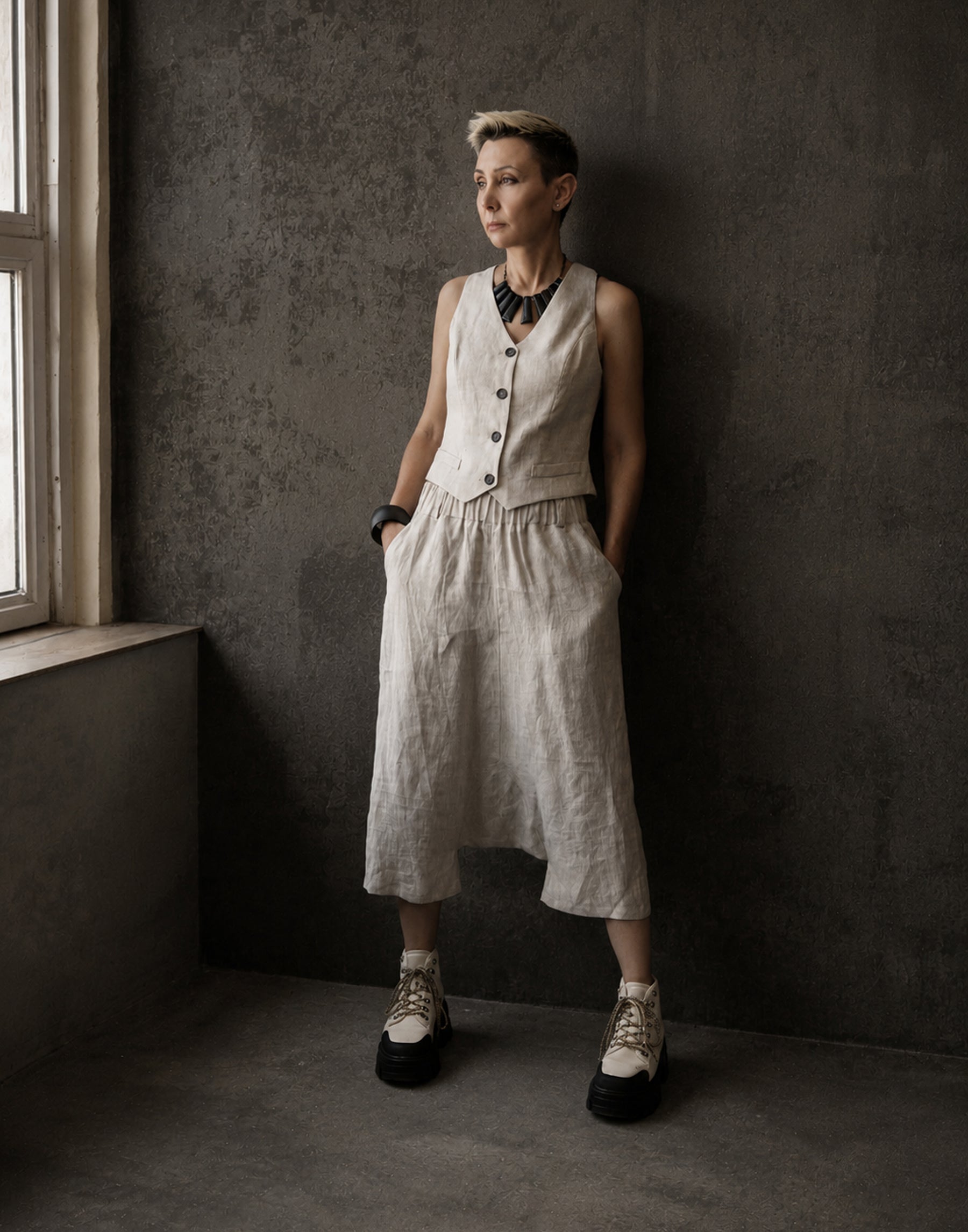 Natural Linen Model wearing unisex linen harem trousers with relaxed drop crotch silhouette