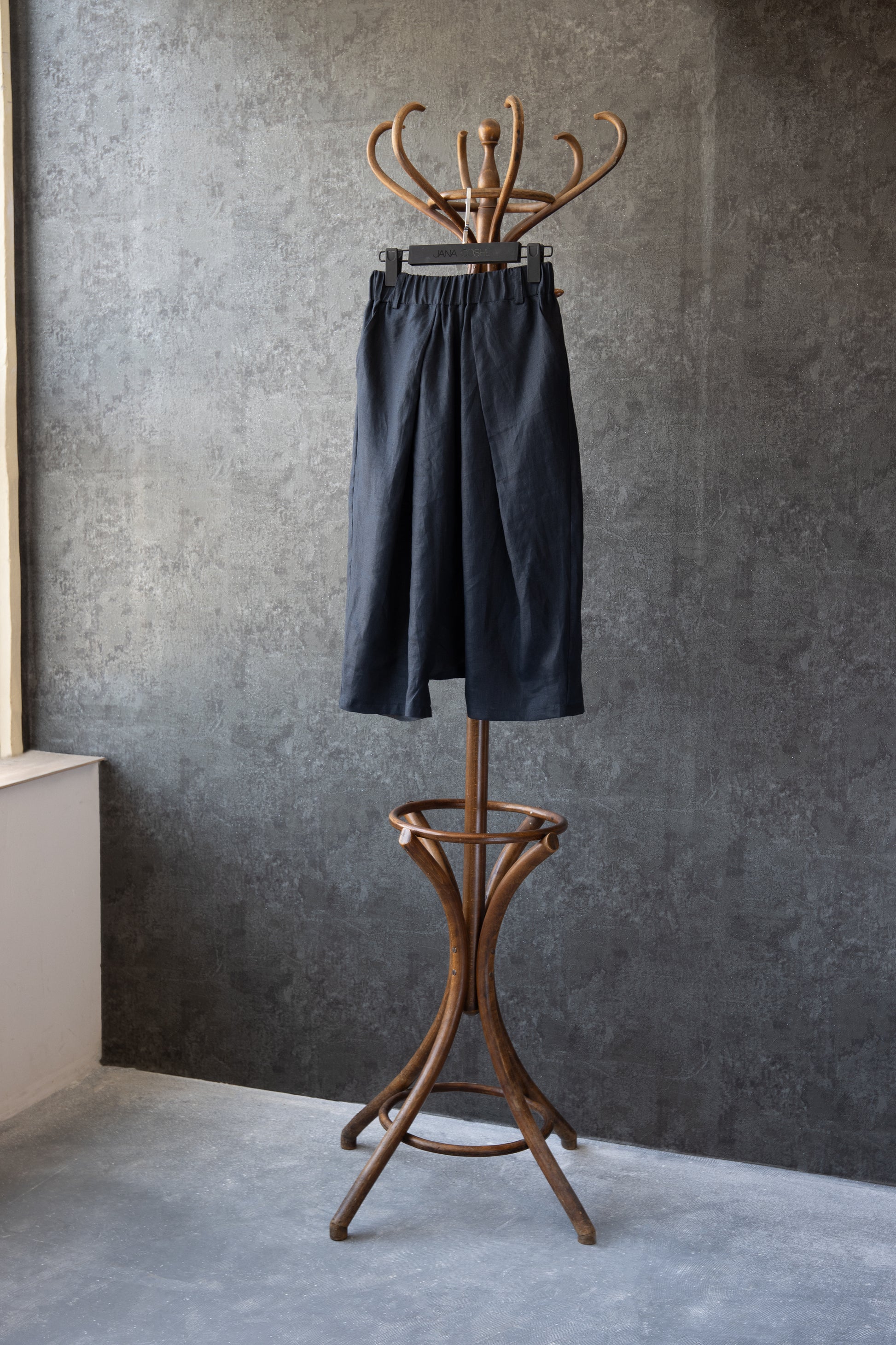 Pants displayed on hanger in artistic studio setting