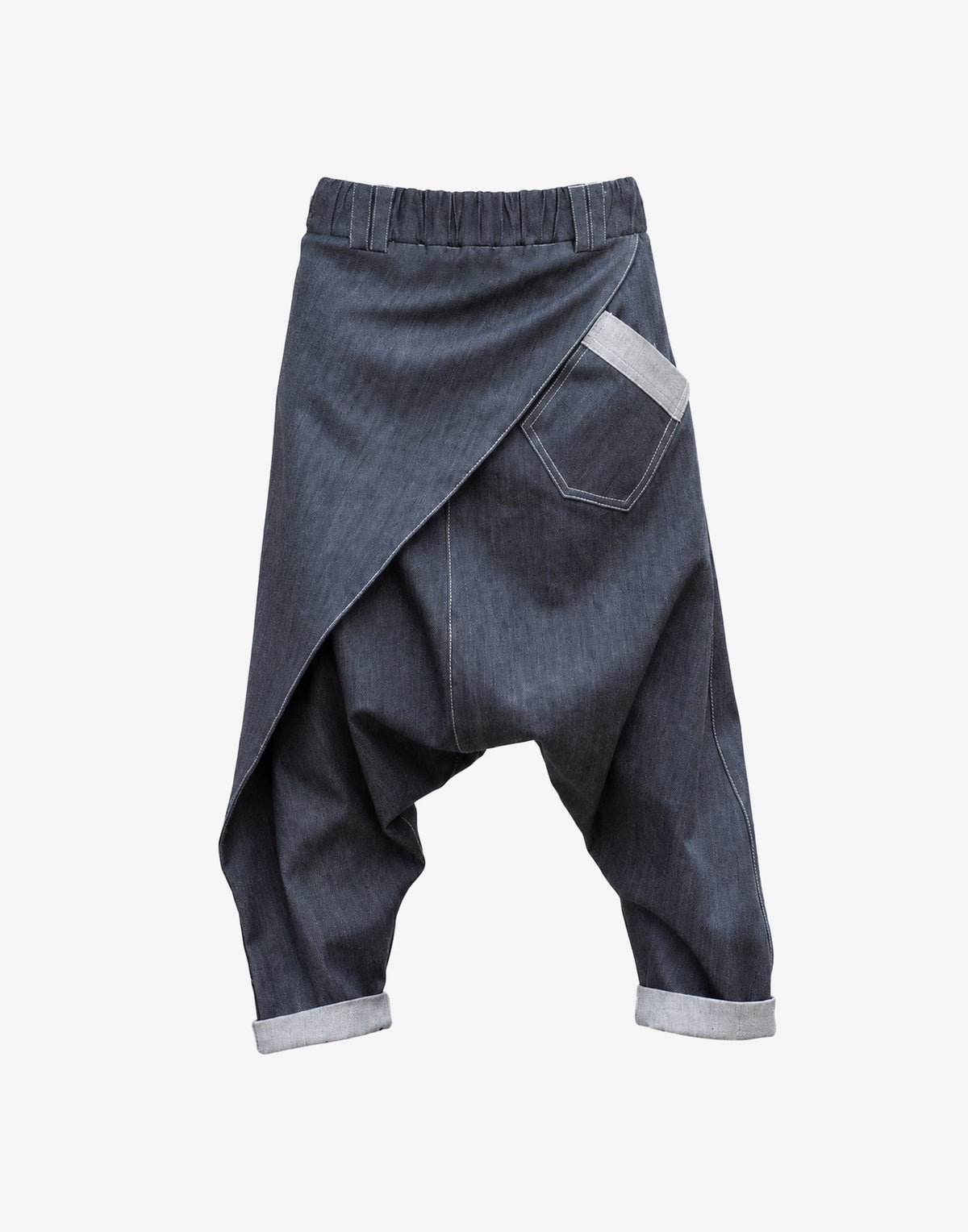 Unisex drop-crotch denim trousers with asymmetric wrap front and patch pocket – front view